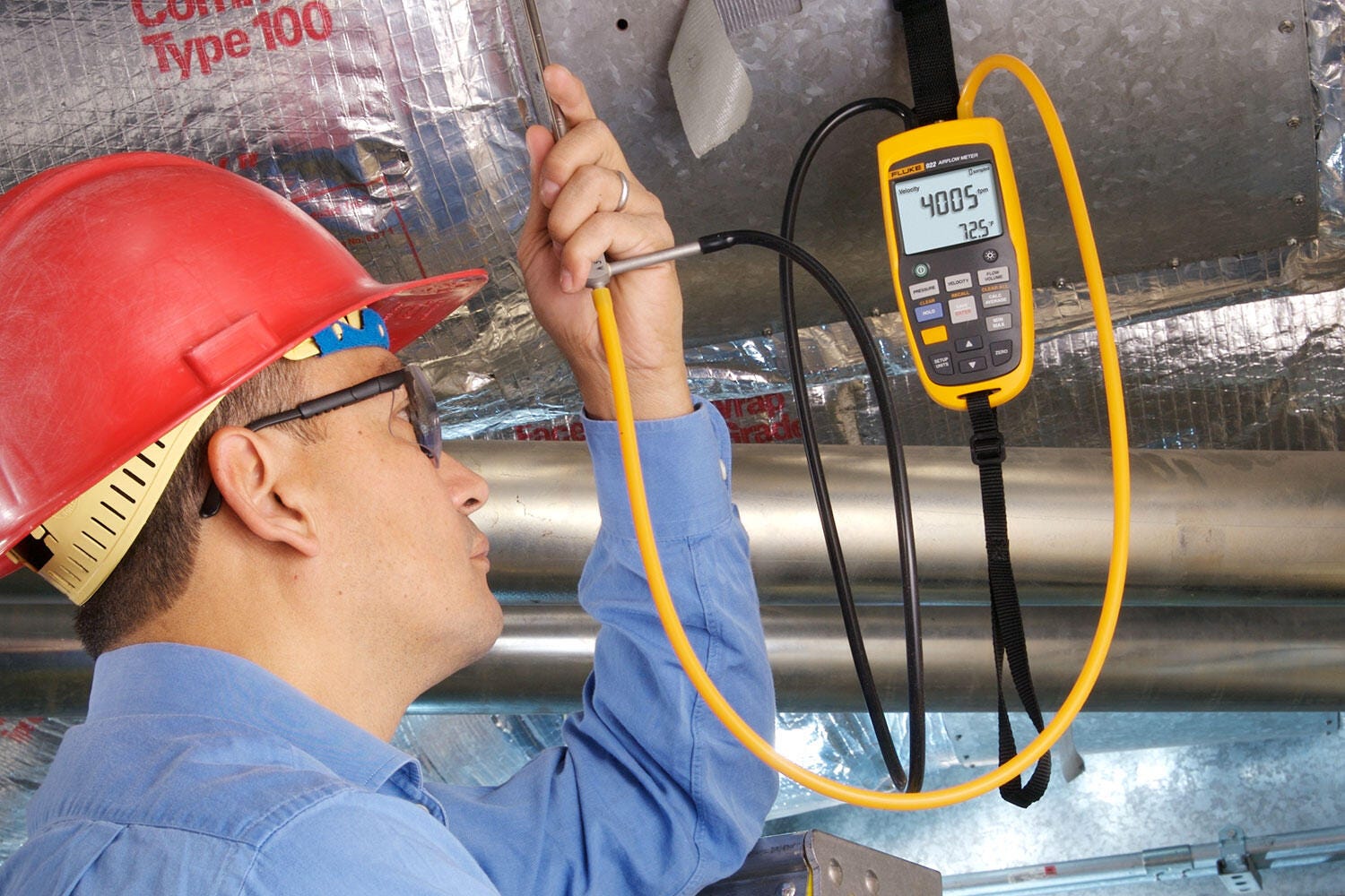 Fluke 922 airflow meter in use on HVAC ductwork